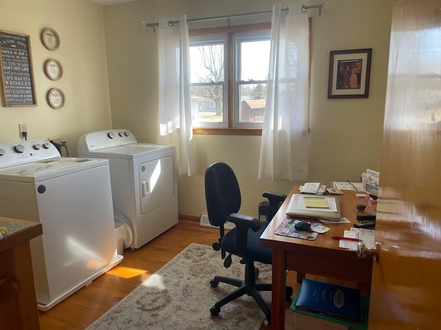 home office with independent washer and dryer and light wood-type flooring