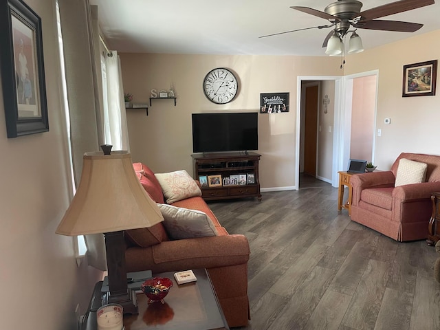 living area featuring ceiling fan, baseboards, and wood finished floors