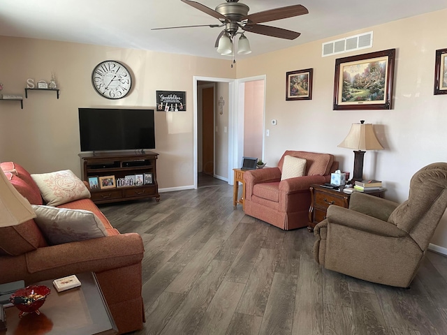 living room featuring visible vents, baseboards, ceiling fan, and wood finished floors