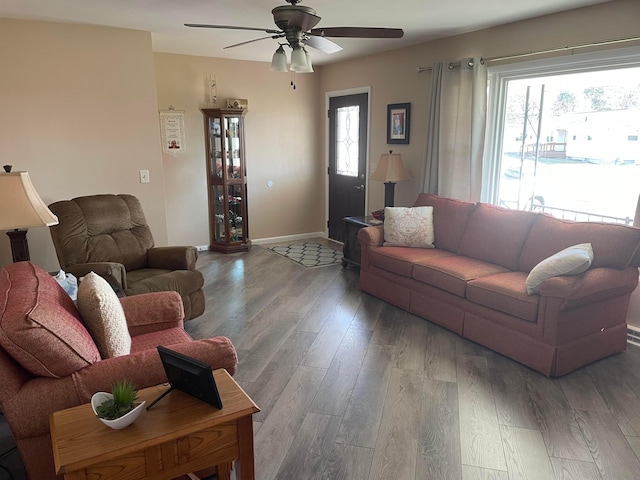 living room featuring a wealth of natural light, baseboards, wood finished floors, and ceiling fan