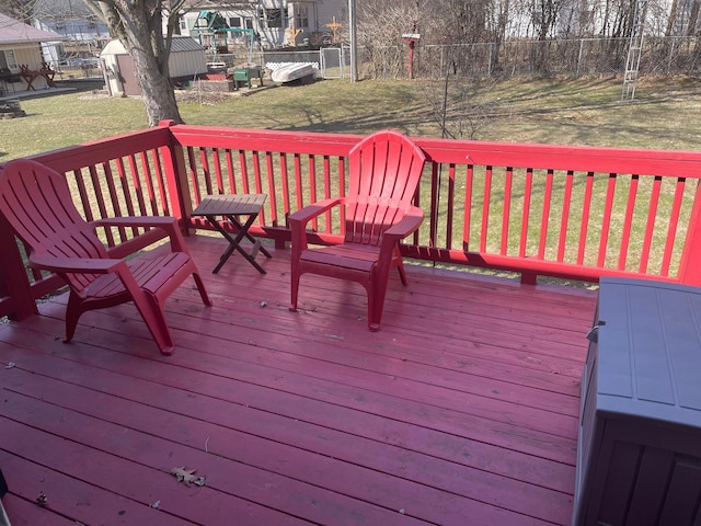 wooden deck featuring a lawn