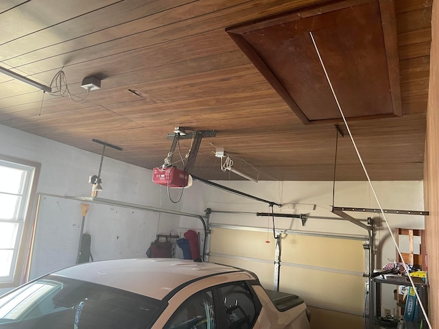 garage featuring wooden ceiling and a garage door opener