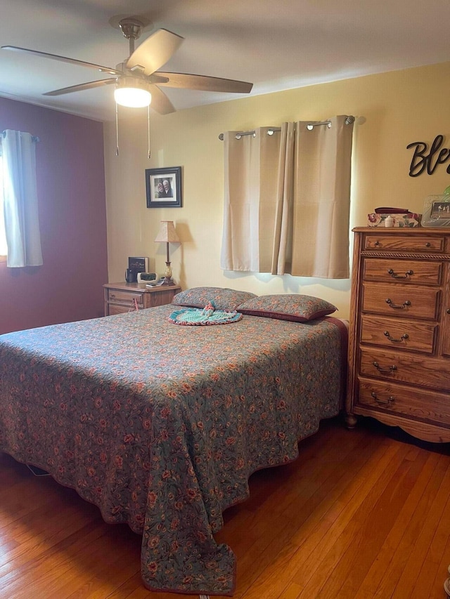 bedroom with hardwood / wood-style flooring and a ceiling fan