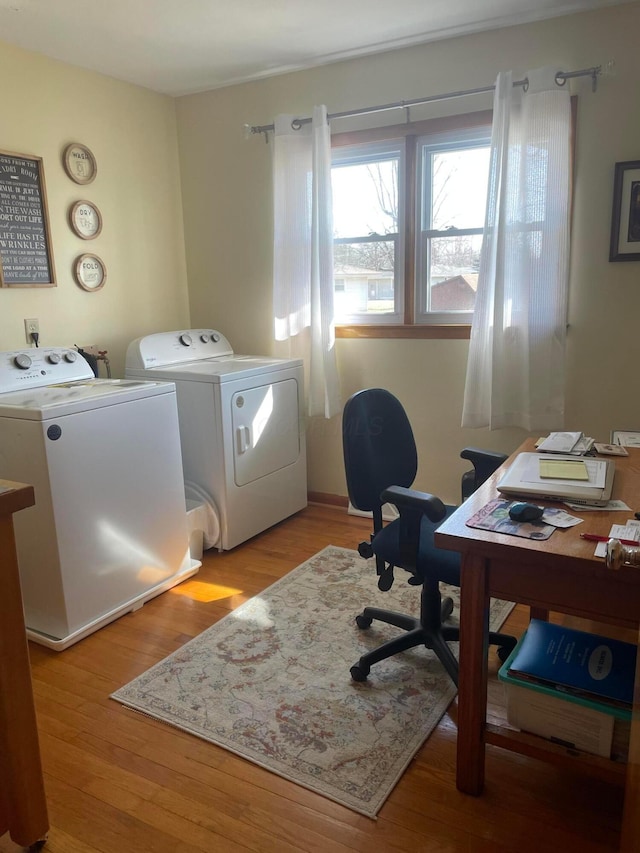 home office featuring light wood-style floors and washing machine and clothes dryer