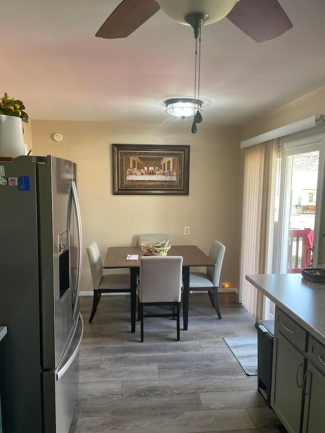 dining area featuring wood finished floors and a ceiling fan