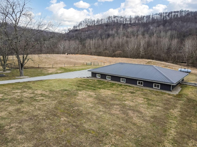 drone / aerial view featuring a wooded view