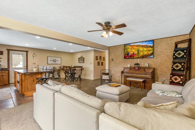 living area featuring tile patterned floors, recessed lighting, a textured ceiling, and ceiling fan