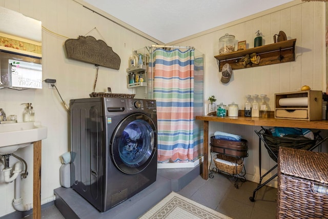 clothes washing area featuring tile patterned floors, laundry area, and washer / clothes dryer