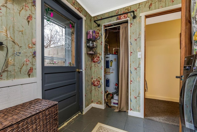 interior space with baseboards, washer / clothes dryer, electric water heater, and wallpapered walls