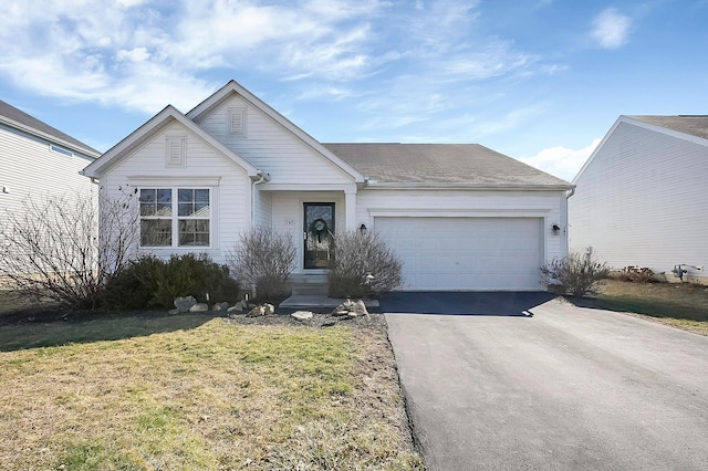 single story home featuring a front yard, a garage, driveway, and a shingled roof