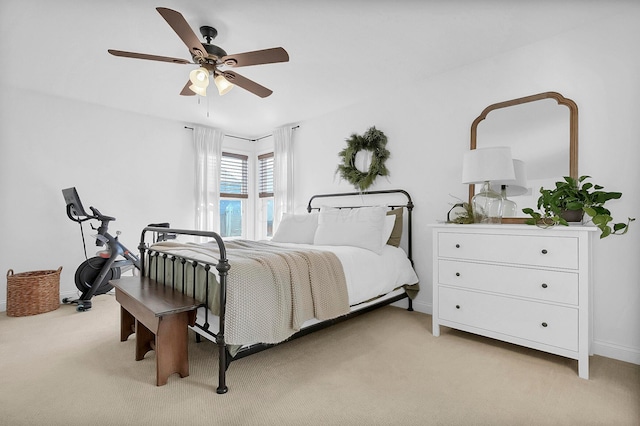 bedroom featuring baseboards, light carpet, and a ceiling fan