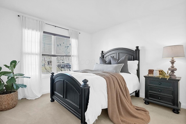 carpeted bedroom featuring baseboards