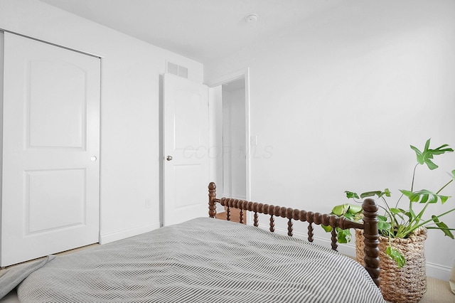 bedroom featuring visible vents and baseboards