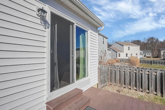 wooden deck with fence and a residential view