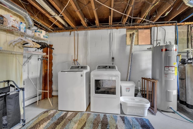 clothes washing area featuring washer and clothes dryer, laundry area, baseboard heating, and electric water heater