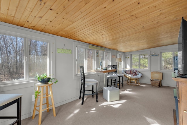 sunroom featuring lofted ceiling and wood ceiling