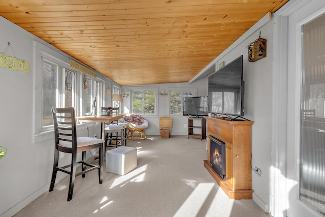 sunroom with a glass covered fireplace, wooden ceiling, and vaulted ceiling