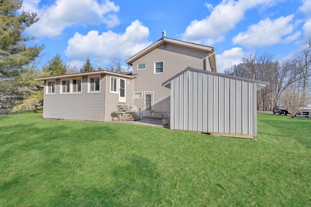 back of property with a yard, a patio, and entry steps