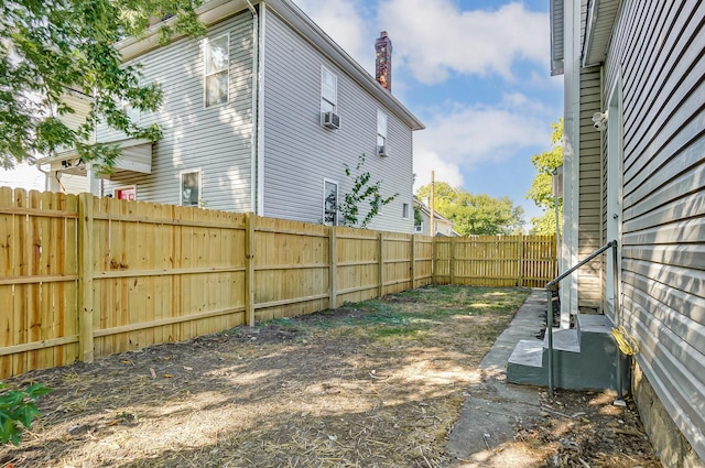 view of yard with cooling unit and a fenced backyard