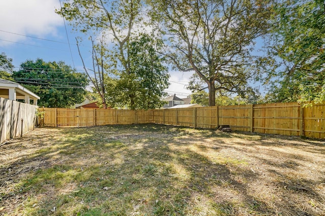 view of yard with a fenced backyard