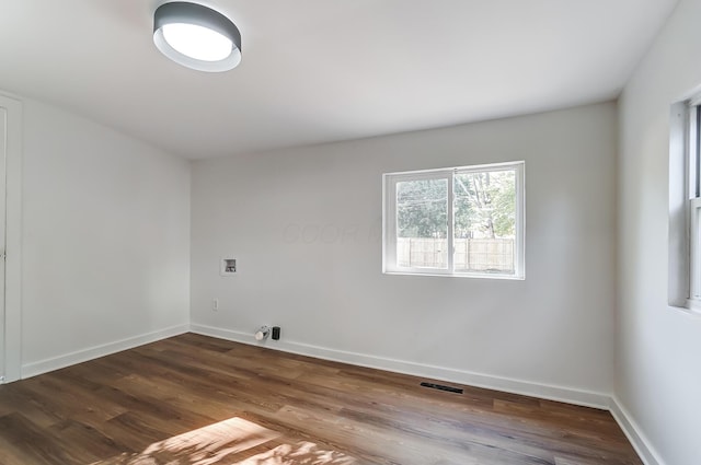 laundry room with visible vents, baseboards, washer hookup, laundry area, and wood finished floors