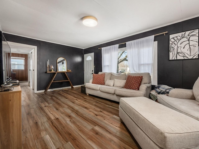 living room with hardwood / wood-style floors, a healthy amount of sunlight, and baseboards