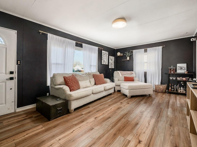 living area with crown molding and hardwood / wood-style floors