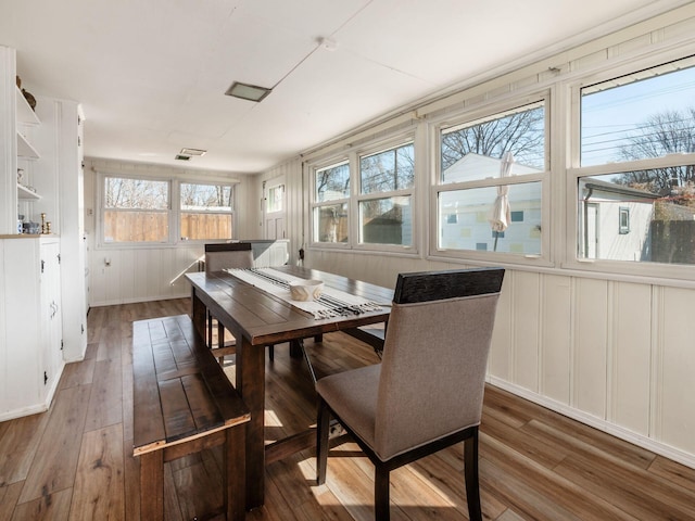 dining space with hardwood / wood-style floors