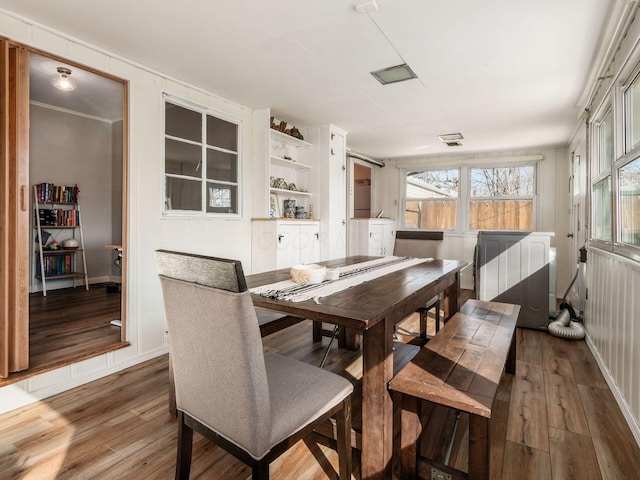 dining space featuring visible vents and hardwood / wood-style floors