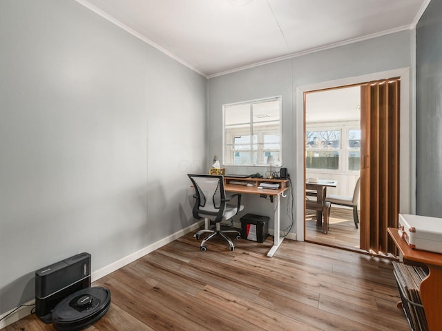 office area featuring baseboards, wood finished floors, and ornamental molding