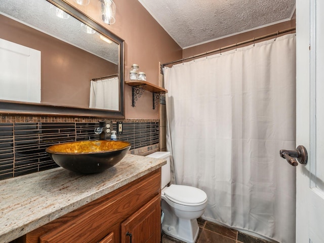 bathroom with tile patterned flooring, toilet, vanity, a shower with curtain, and a textured ceiling