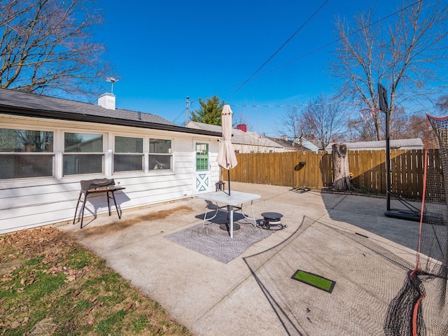 view of patio featuring fence