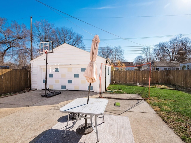 exterior space with a fenced backyard, a garage, and an outdoor structure