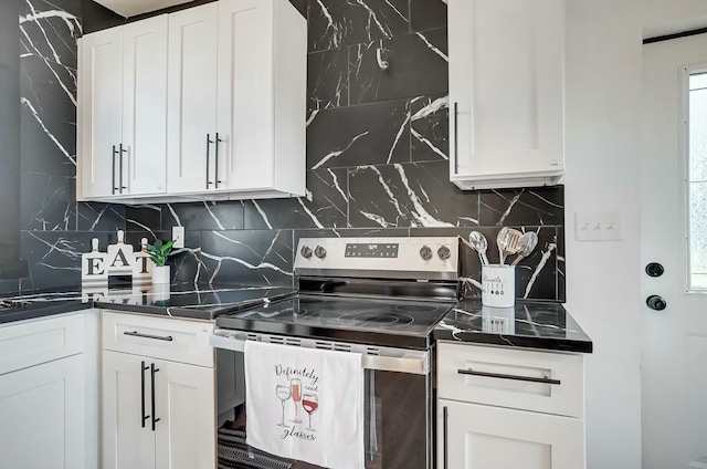 kitchen with decorative backsplash, dark countertops, stainless steel range with electric stovetop, and white cabinets