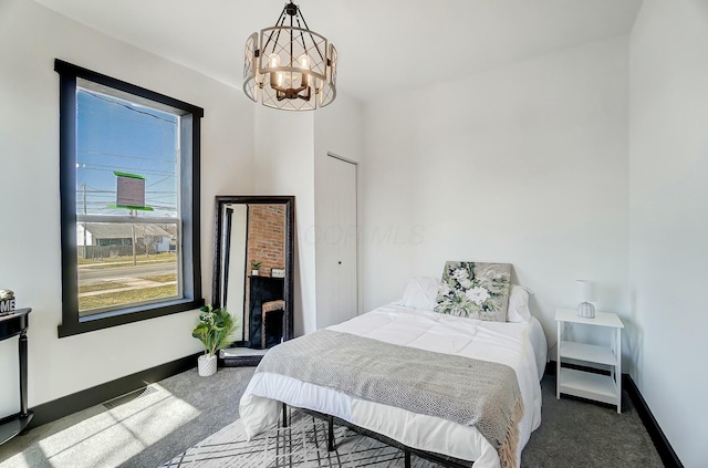 bedroom with a chandelier, carpet flooring, visible vents, and baseboards