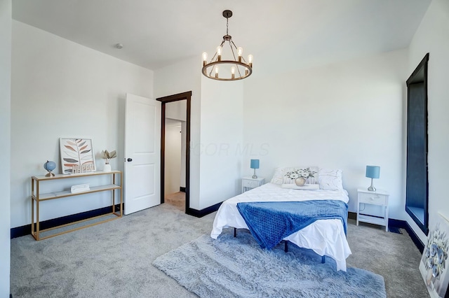 bedroom with a notable chandelier, baseboards, and carpet