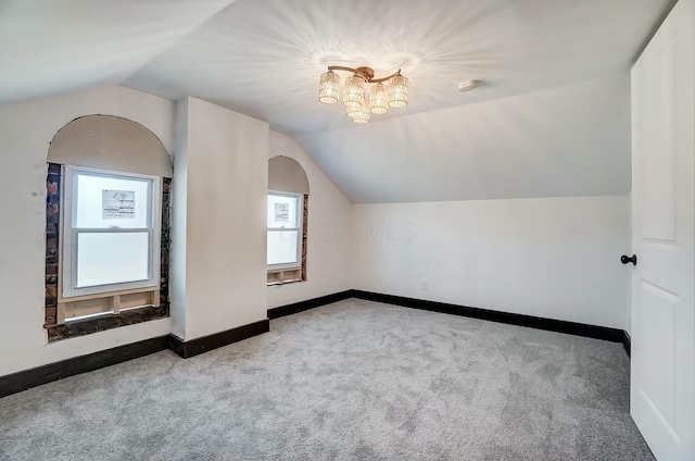 bonus room with vaulted ceiling, baseboards, and carpet floors