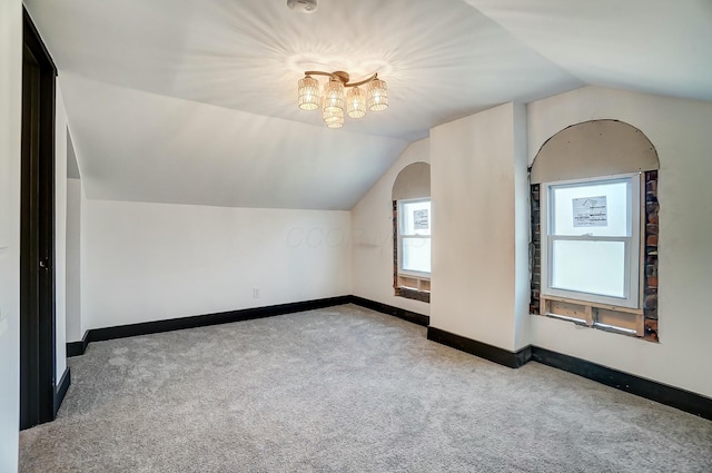 bonus room featuring baseboards, carpet, and vaulted ceiling