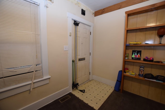 foyer entrance with visible vents and baseboards