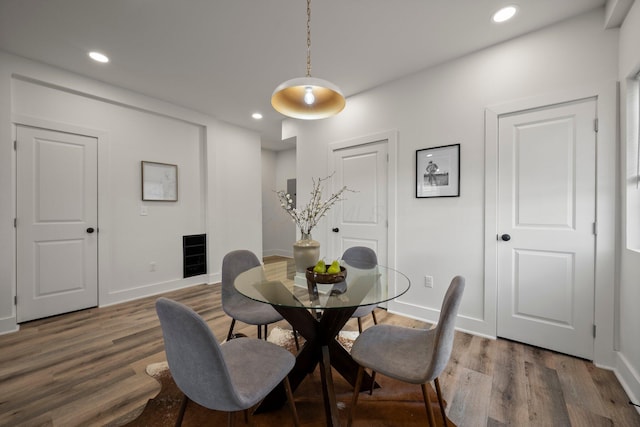 dining area with recessed lighting, baseboards, and wood finished floors