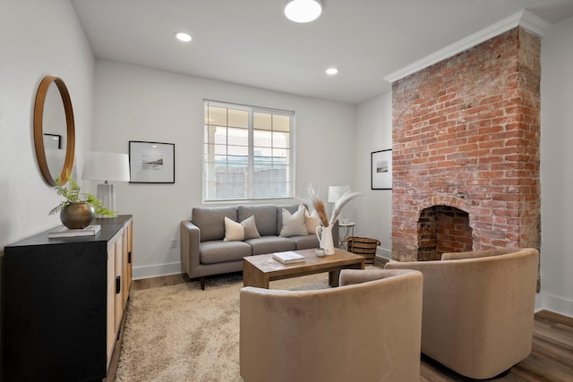 living room featuring recessed lighting, a brick fireplace, baseboards, and light wood-style floors