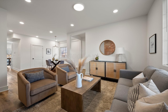 living room featuring recessed lighting, baseboards, and wood finished floors