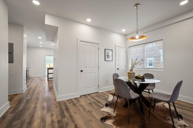 dining room with electric panel, recessed lighting, wood finished floors, and baseboards