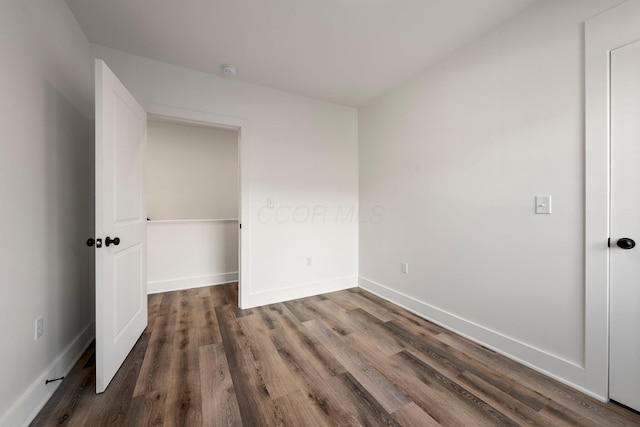 unfurnished bedroom featuring baseboards and wood finished floors