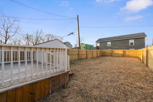 view of yard featuring a deck and a fenced backyard