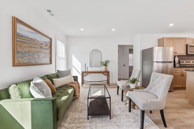 living area featuring recessed lighting, visible vents, and light wood finished floors