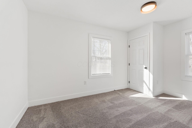 empty room with baseboards and carpet floors