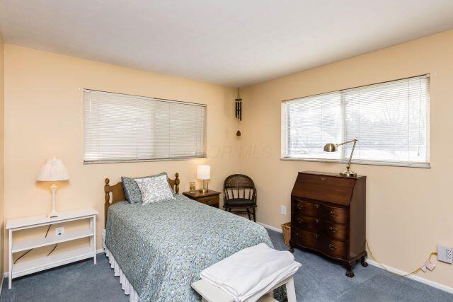 carpeted bedroom featuring baseboards