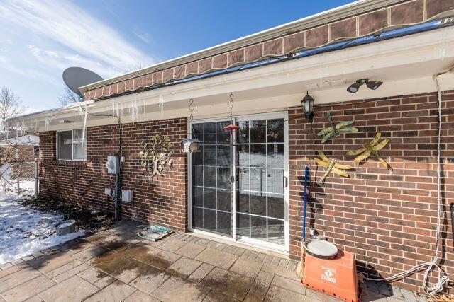 entrance to property with brick siding