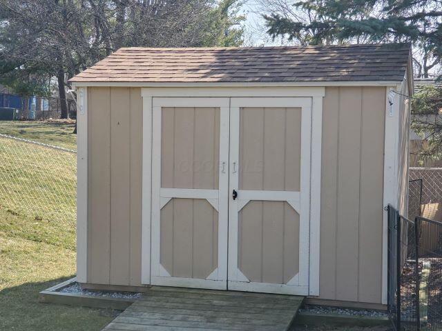 view of shed with fence